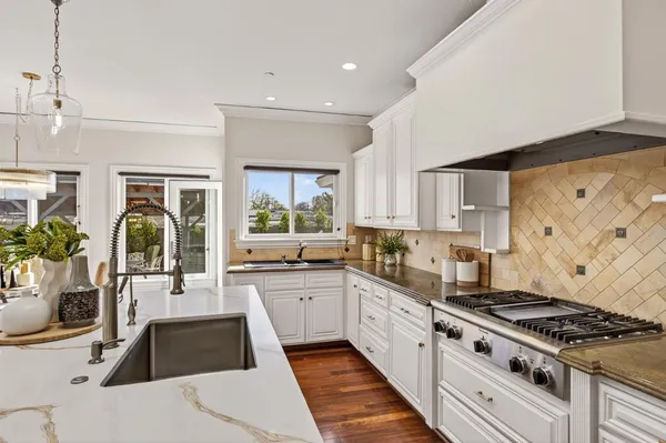 a kitchen with a stove a sink and a refrigerator