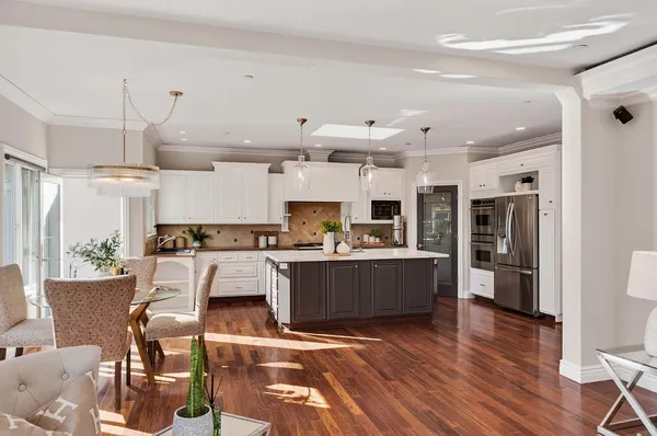 a large white kitchen with a table and chairs