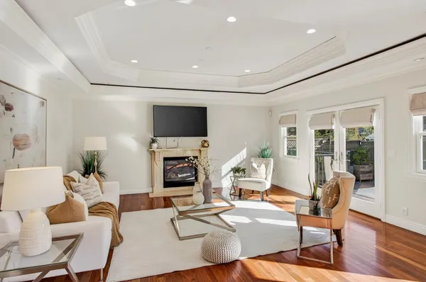 a living room with furniture a flat screen tv and a fireplace