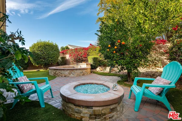 a view of a chairs and table in backyard