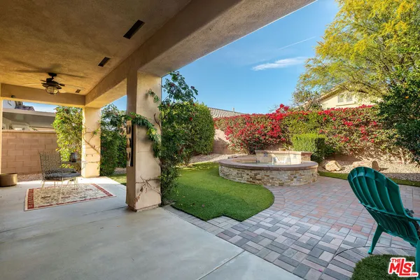 a view of patio with couches table and chairs and potted plants