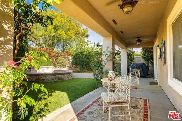 a view of a patio with table and chairs and potted plants