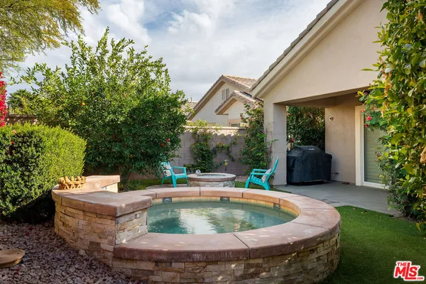 a view of a house with pool and chairs