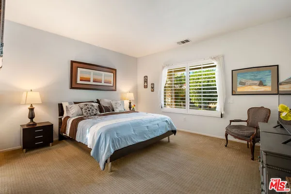 a spacious bedroom with a bed and a couch