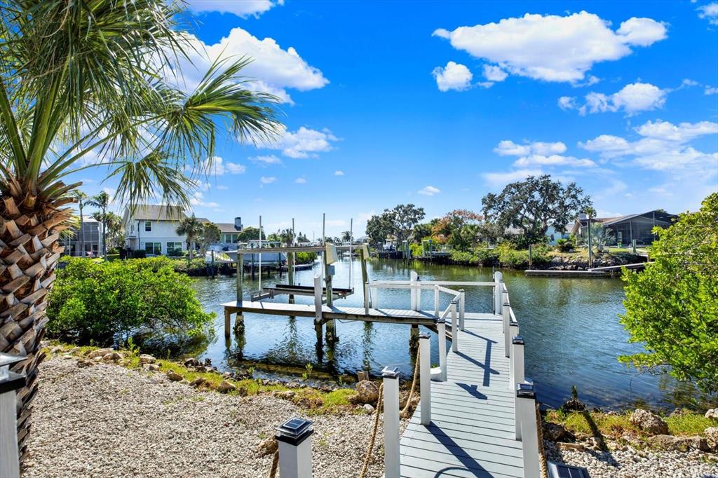 4346 Marine Parkway New Port Richey, FL 34652 - Photo 11 of 61 a view of a lake with a house and a garden