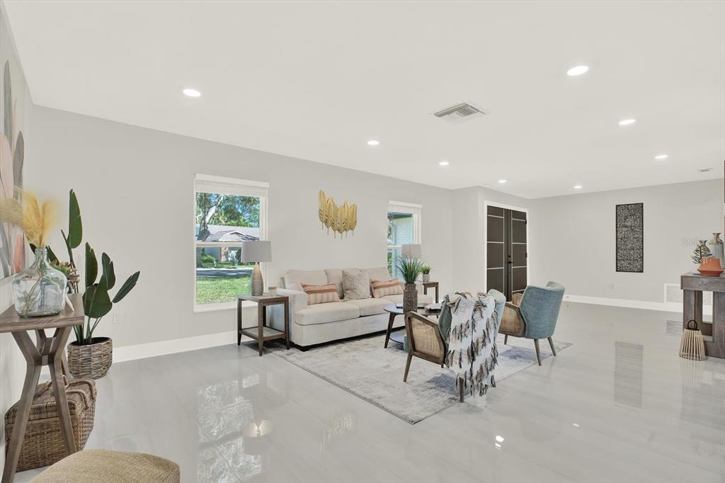 4346 Marine Parkway New Port Richey, FL 34652 - Photo 16 of 61 a living room with furniture a window and a flat screen tv