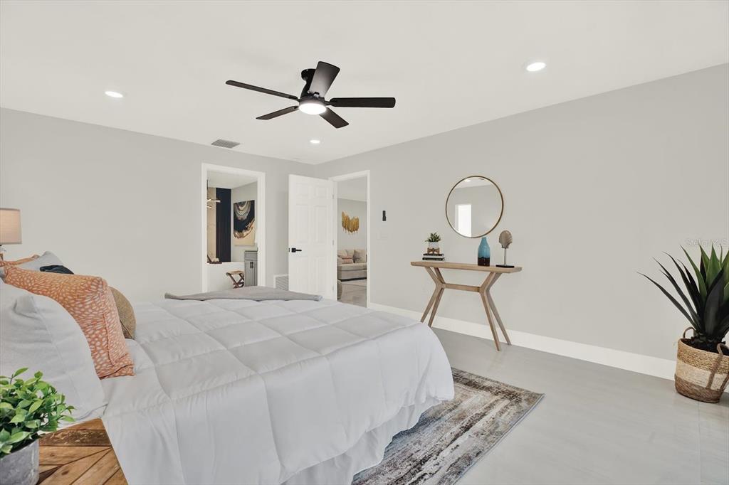 4346 Marine Parkway New Port Richey, FL 34652 - Photo 24 of 61 a bedroom with a bed and a chandelier