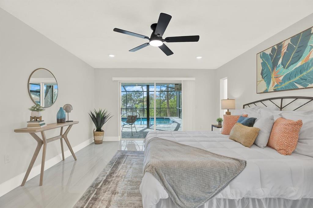 4346 Marine Parkway New Port Richey, FL 34652 - Photo 27 of 61 a bedroom with a bed and a chandelier