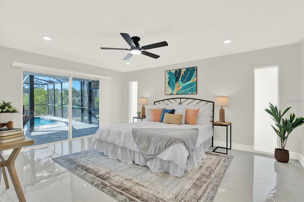 4346 Marine Parkway New Port Richey, FL 34652 - Photo 28 of 61 a bedroom with a large bed and a large window