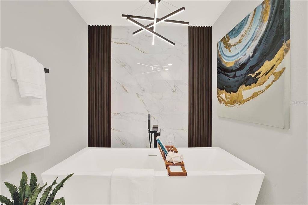 4346 Marine Parkway New Port Richey, FL 34652 - Photo 29 of 61 a bedroom with a bed and a chandelier