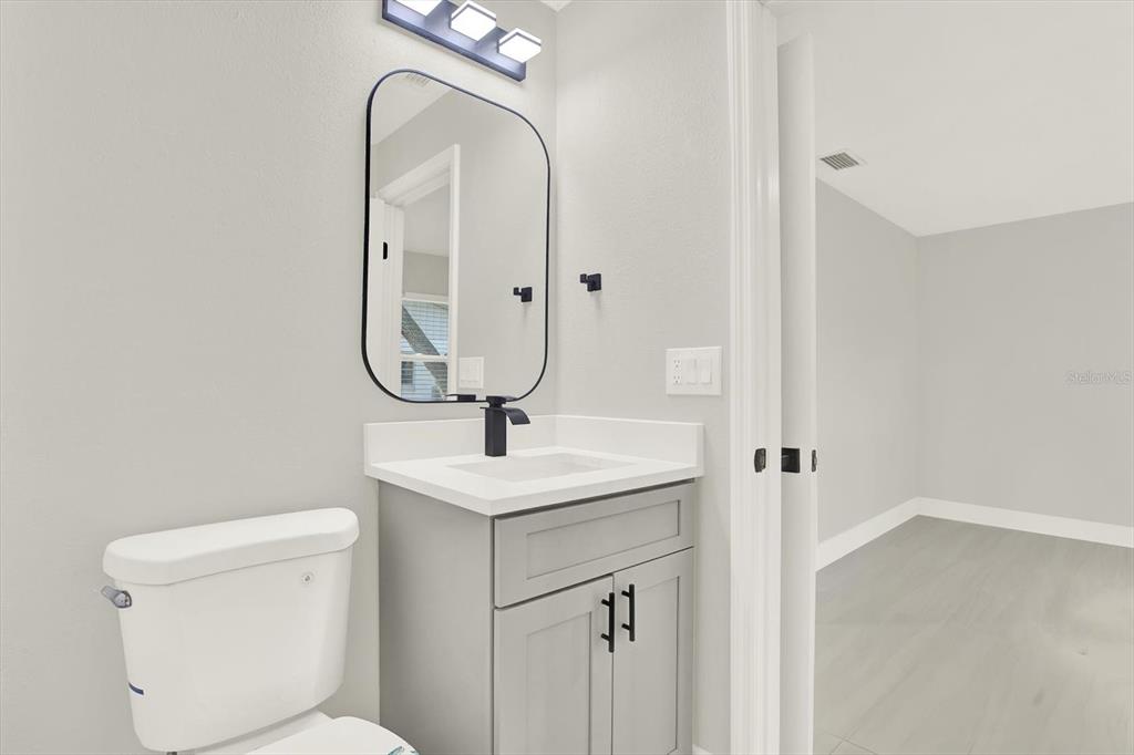 4346 Marine Parkway New Port Richey, FL 34652 - Photo 35 of 61 a bathroom with a toilet sink and mirror