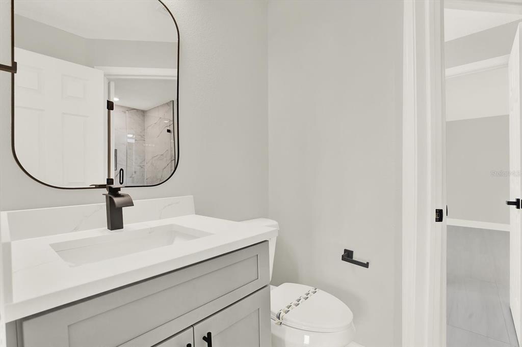 4346 Marine Parkway New Port Richey, FL 34652 - Photo 37 of 61 a bathroom with a sink toilet vanity and shower