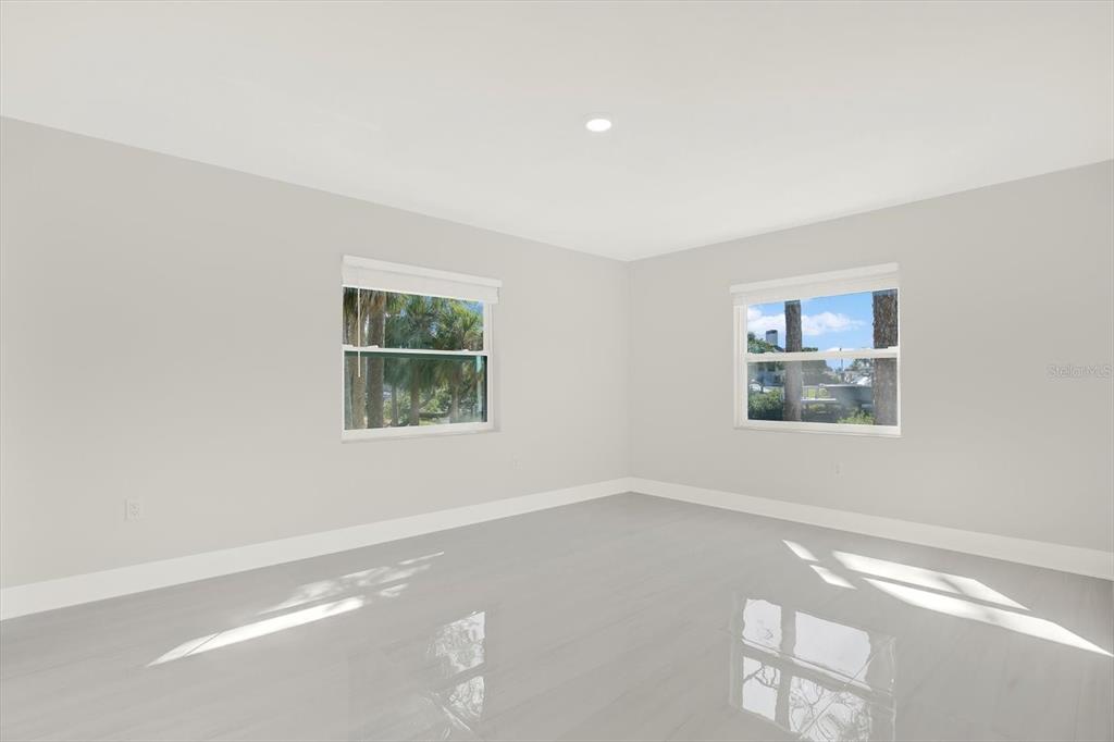4346 Marine Parkway New Port Richey, FL 34652 - Photo 39 of 61 a view of a big room with windows and chandelier fan