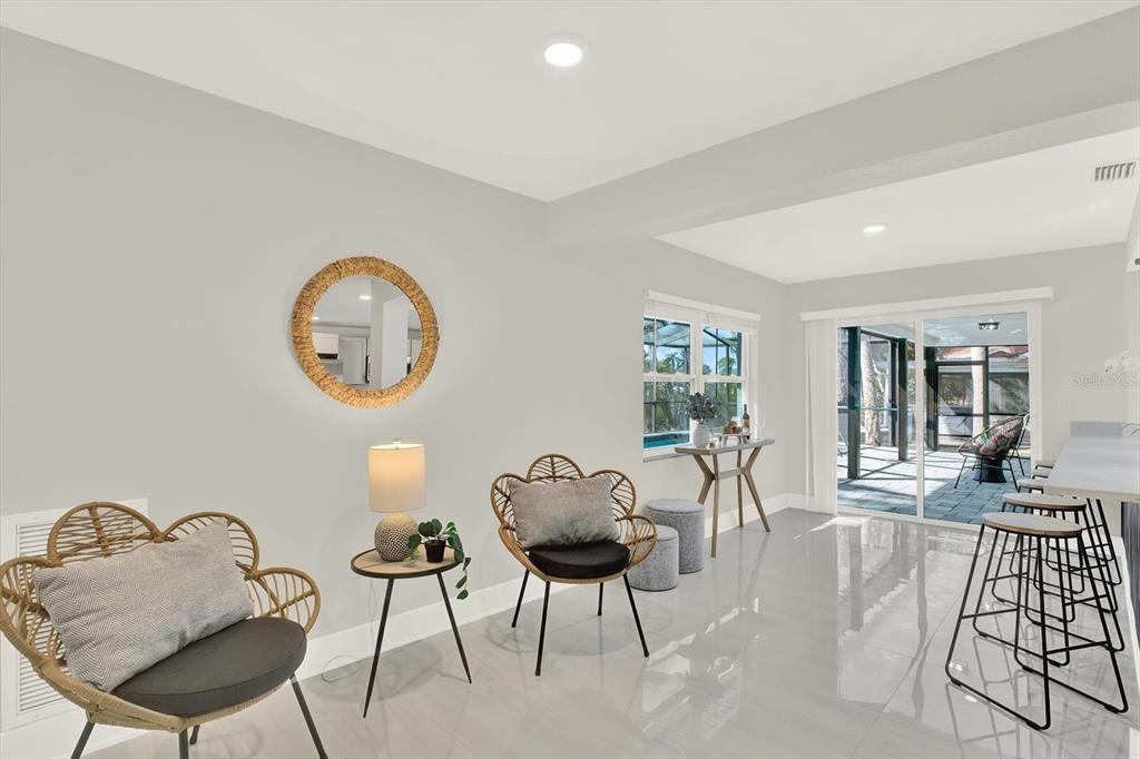 4346 Marine Parkway New Port Richey, FL 34652 - Photo 42 of 61 a living room with furniture a mirror and a large window