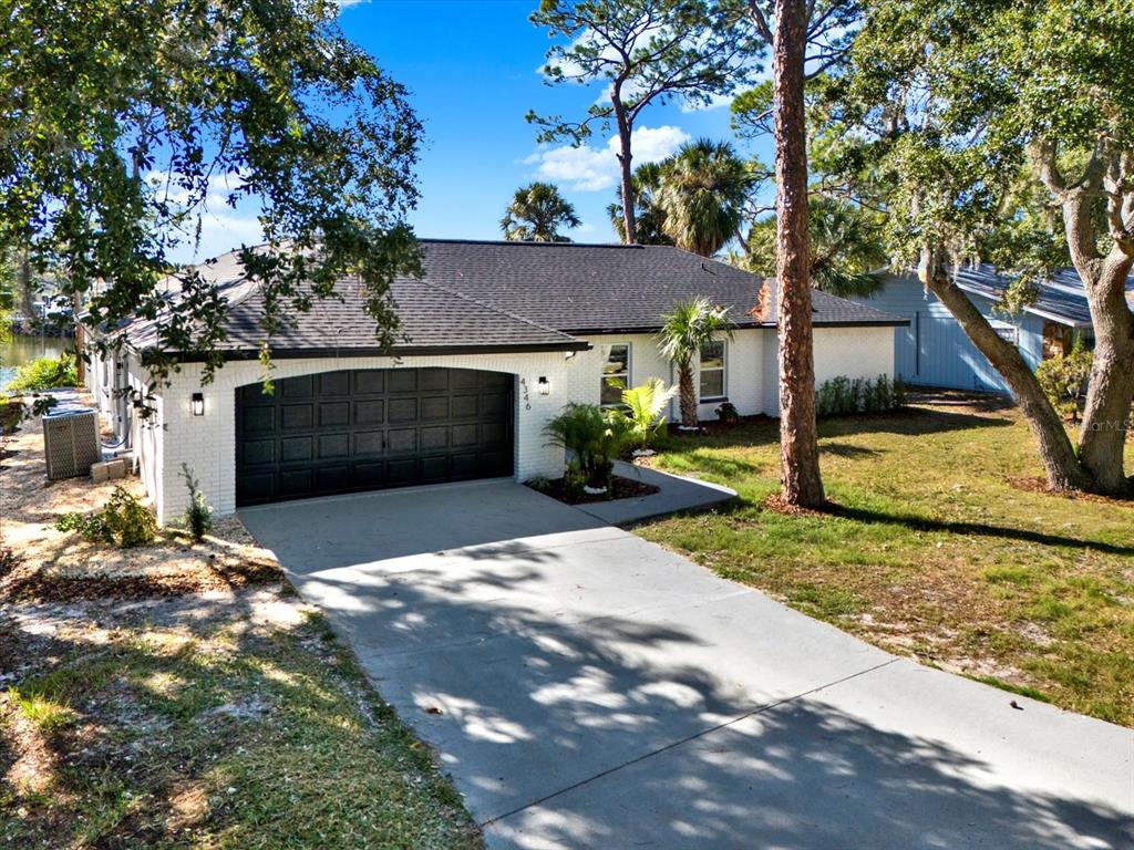 4346 Marine Parkway New Port Richey, FL 34652 - Photo 45 of 61 a front view of a house with a yard and garage