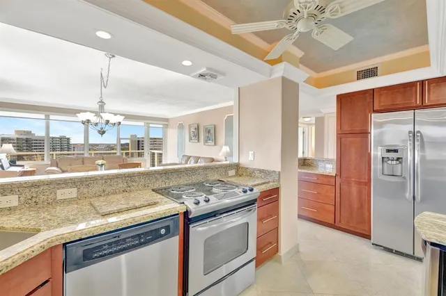 a kitchen with stainless steel appliances granite countertop a sink and a refrigerator