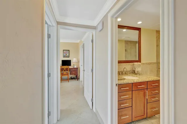 a en suite bathroom with a granite countertop sink and a mirror