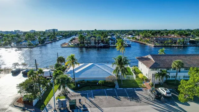 a dining room with furniture large windows and a chandelier