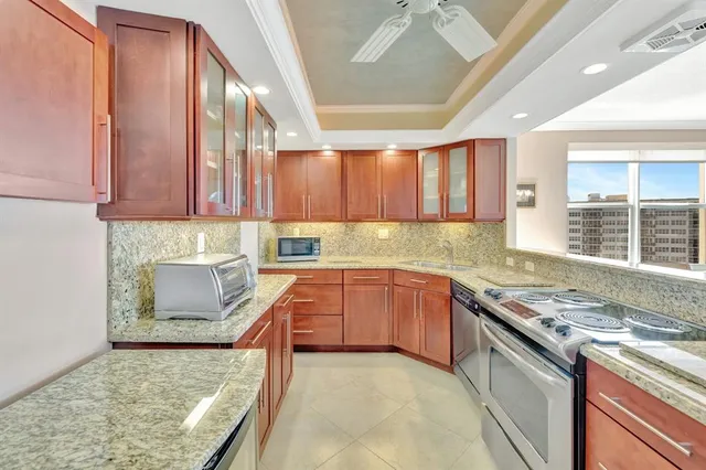 a kitchen with stainless steel appliances granite countertop a stove sink and cabinets