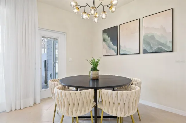 a dining room with furniture and a chandelier