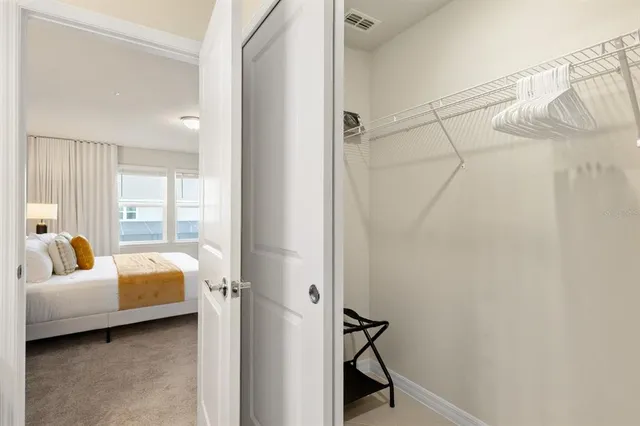 a bedroom with a bed and a painting on the wall