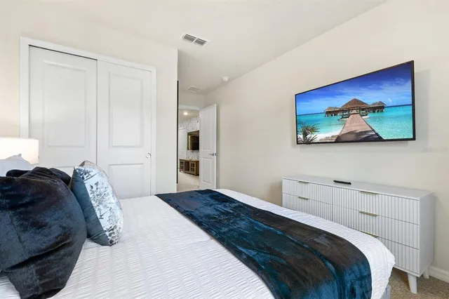 a bedroom with bed and a chandelier