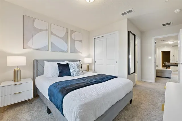 a bedroom with a large bed and a window