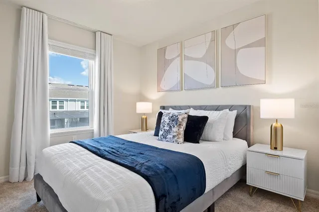 a spacious bedroom with a bed and a dresser