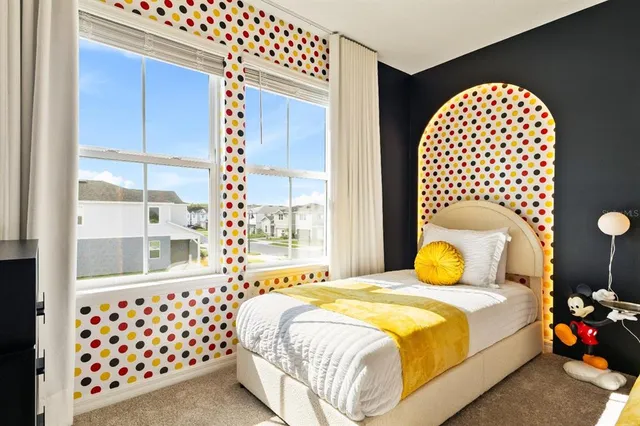 a bedroom with two beds and a large window