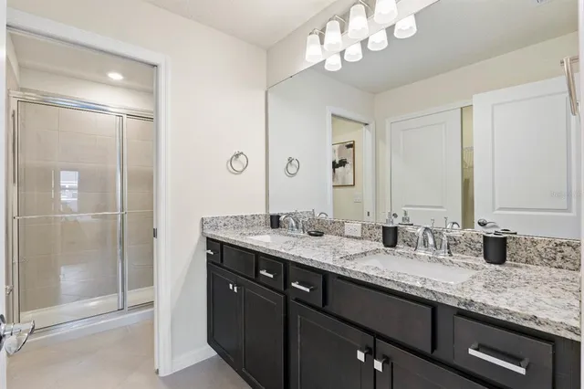 a spacious bedroom with a bed and a dresser