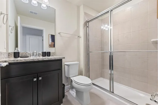 a bathroom with a shower and a toilet