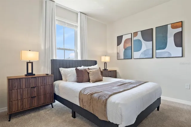 a spacious bedroom with a bed and a glass door