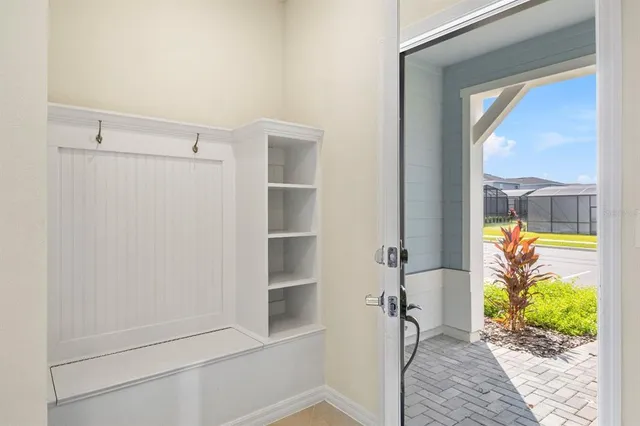 a view of a big room with furniture and large windows