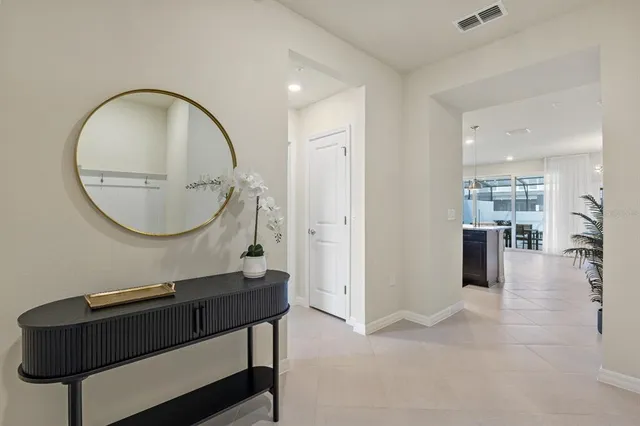 a kitchen with stainless steel appliances kitchen island granite countertop a sink and a refrigerator
