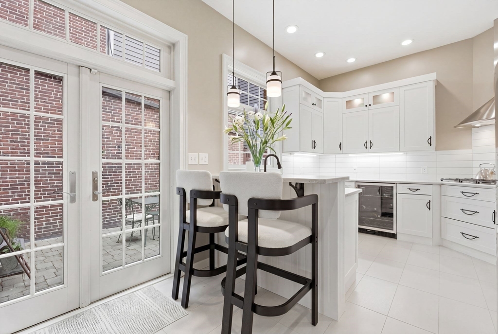 419 Main Street Boston, MA 02129 - Photo 8 of 41 a kitchen with stainless steel appliances kitchen island granite countertop a table chairs sink and cabinets