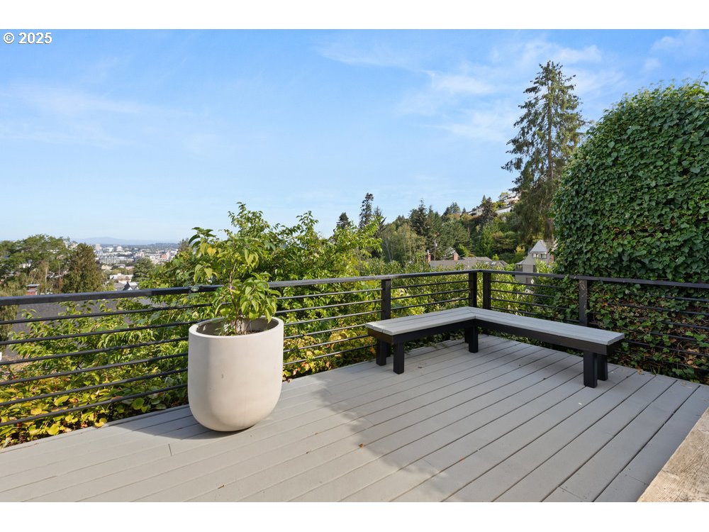 2677 Northwest Westover Road Portland, OR 97210 - Photo 13 of 48 a view of a roof deck with table and chairs potted plants with wooden floor