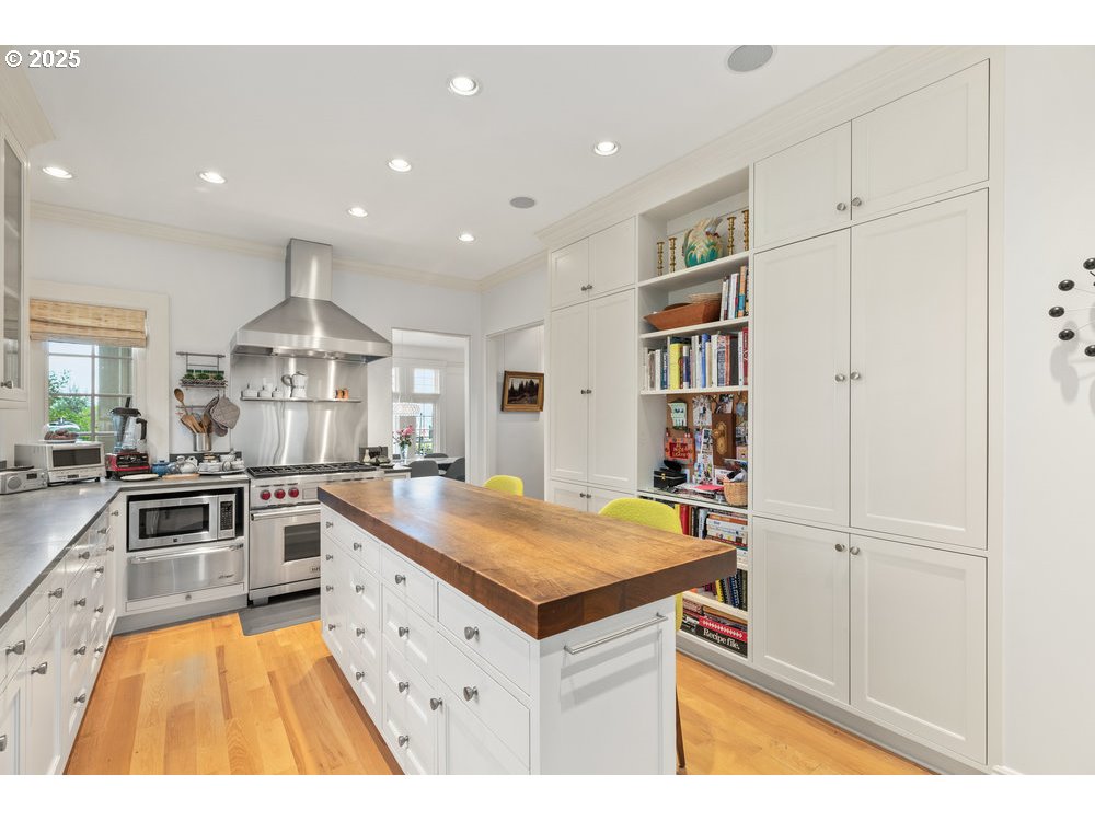 2677 Northwest Westover Road Portland, OR 97210 - Photo 22 of 48 a kitchen with stainless steel appliances granite countertop a sink and cabinets