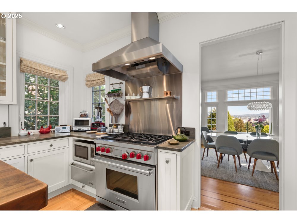 2677 Northwest Westover Road Portland, OR 97210 - Photo 23 of 48 a kitchen with a stove and a wooden floor