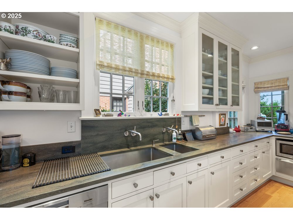 2677 Northwest Westover Road Portland, OR 97210 - Photo 24 of 48 a kitchen with granite countertop a sink a counter space and cabinets