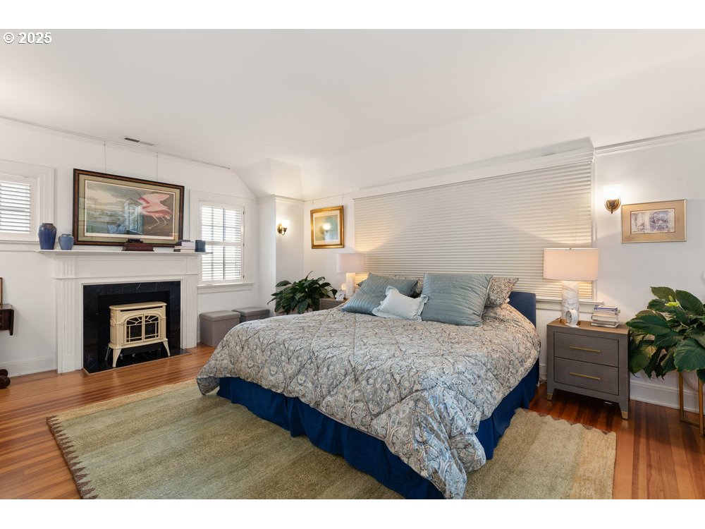 2677 Northwest Westover Road Portland, OR 97210 - Photo 28 of 48 a bedroom with a large bed and a fireplace