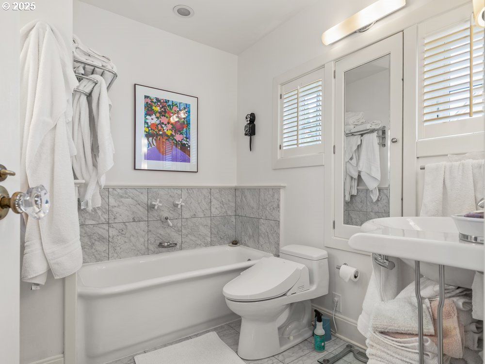 2677 Northwest Westover Road Portland, OR 97210 - Photo 30 of 48 a bathroom with a toilet a sink and bathtub