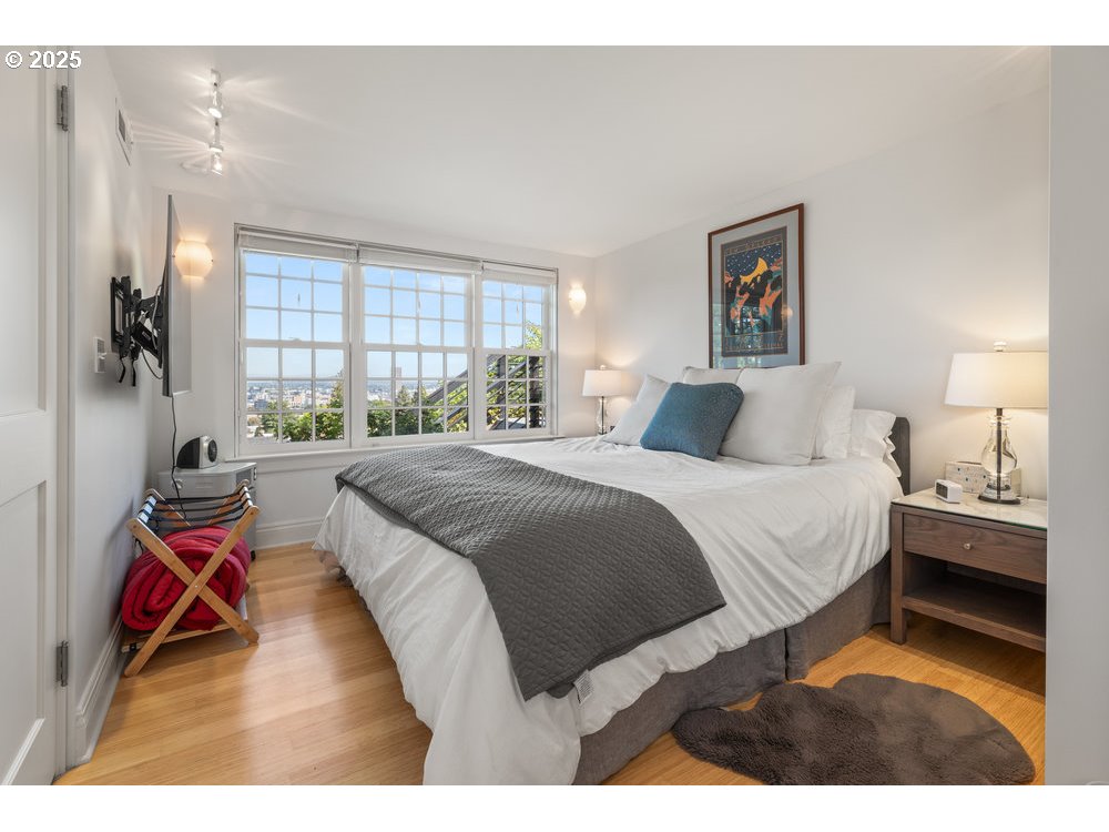 2677 Northwest Westover Road Portland, OR 97210 - Photo 31 of 48 a bedroom with a bed and wooden floor