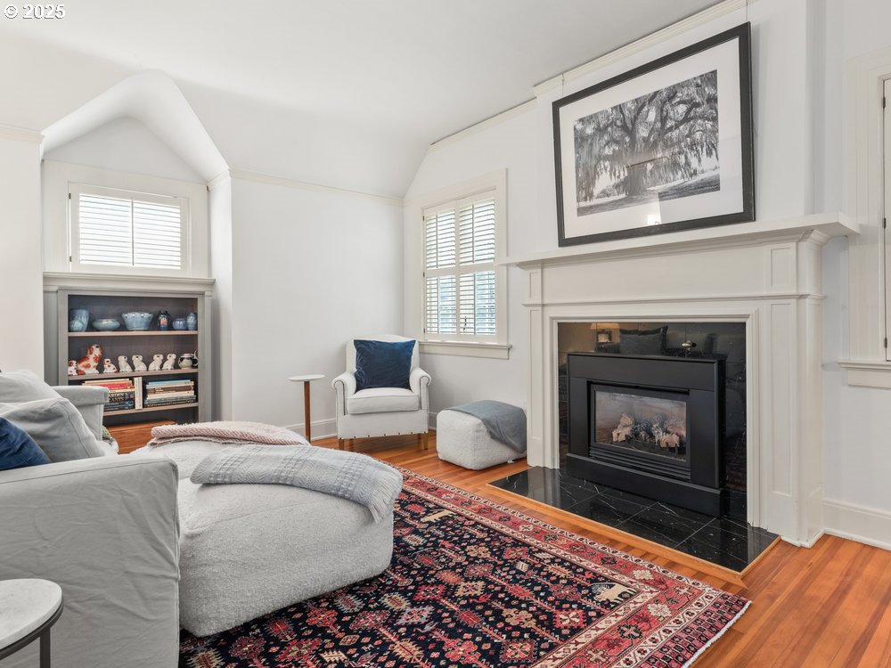 2677 Northwest Westover Road Portland, OR 97210 - Photo 32 of 48 a living room with furniture a rug and a fireplace