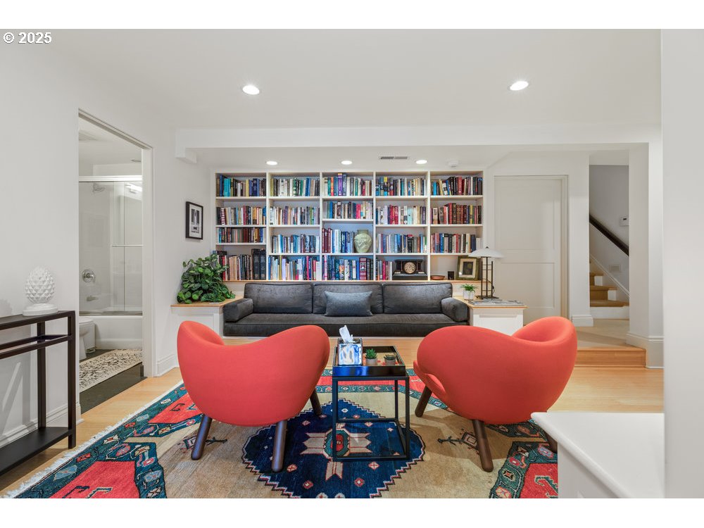 2677 Northwest Westover Road Portland, OR 97210 - Photo 37 of 48 a living room with furniture a rug and a bookshelf