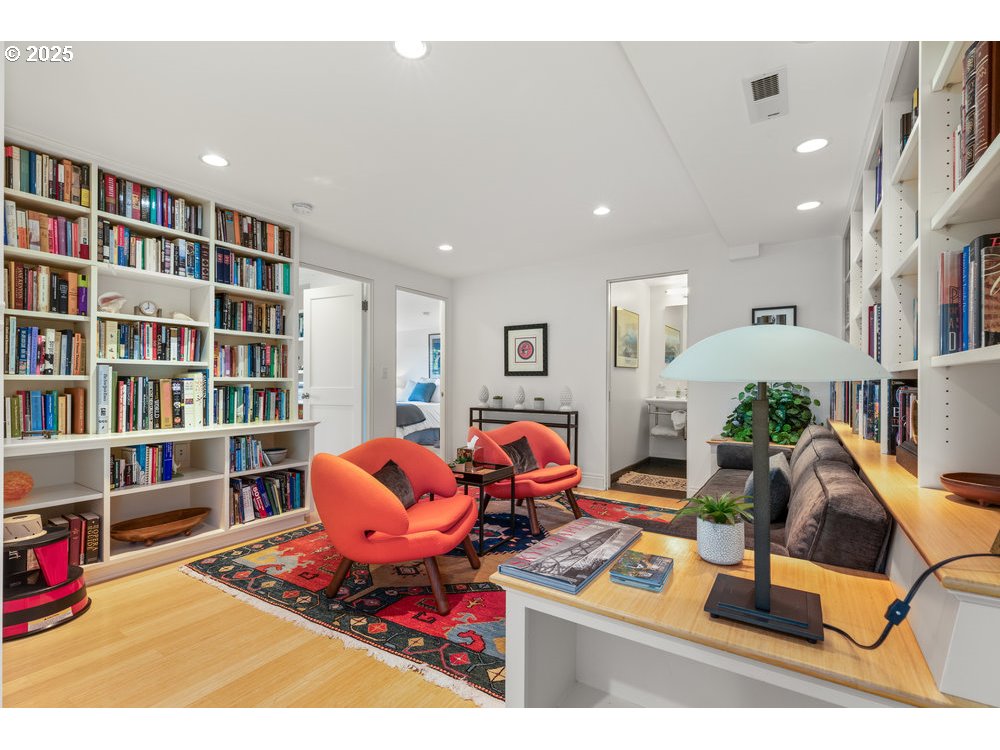 2677 Northwest Westover Road Portland, OR 97210 - Photo 38 of 48 a living room with furniture a book shelf and a book shelf