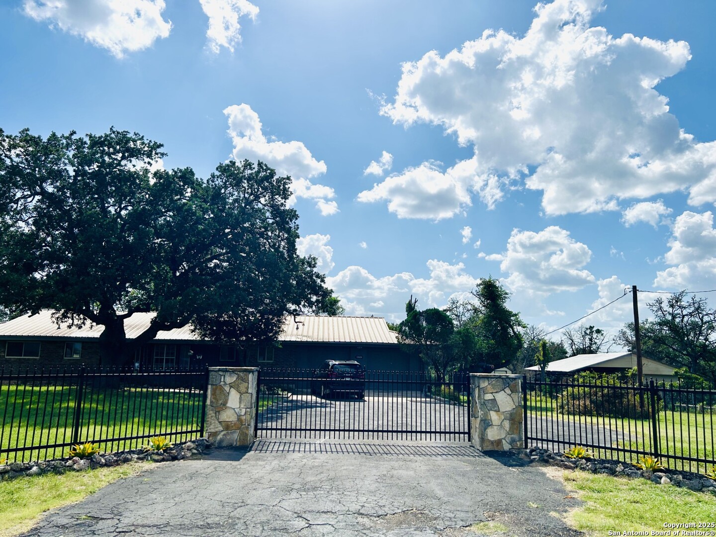 a view of a house with a fence in the background