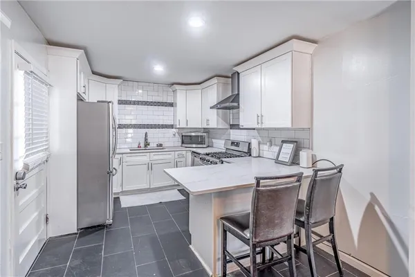 a kitchen with kitchen island a sink counter and chairs
