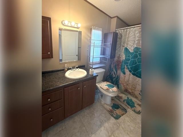 3251 E Road, Unit 11 Clifton, CO 81520 - Photo 12 of 15 a bathroom with a granite countertop sink toilet and shower