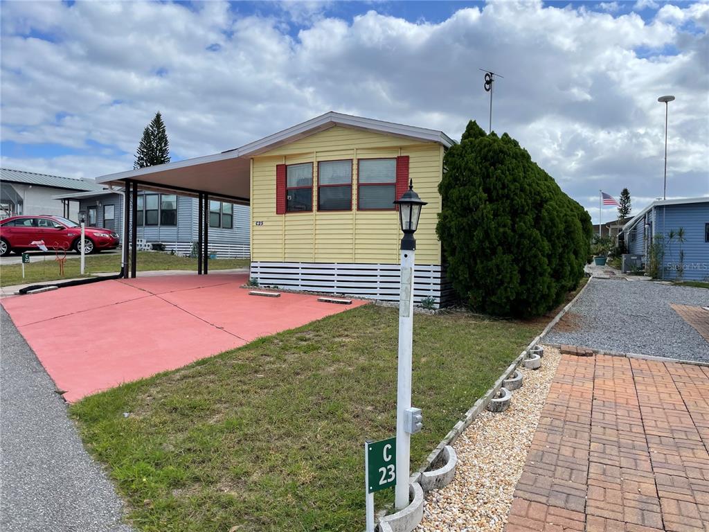 251 Patterson Road, Unit C25 Haines City, FL 33844 - Photo 2 of 10 a front view of a house with garden