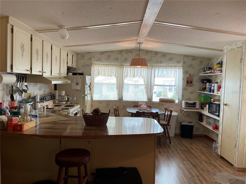 251 Patterson Road, Unit C25 Haines City, FL 33844 - Photo 5 of 10 a kitchen with a refrigerator and a stove top oven